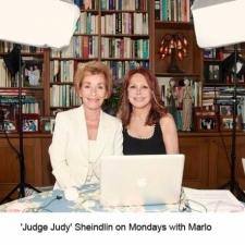  Judge Judy wearing a white pantsuit designed by Susanna Beverly Hills